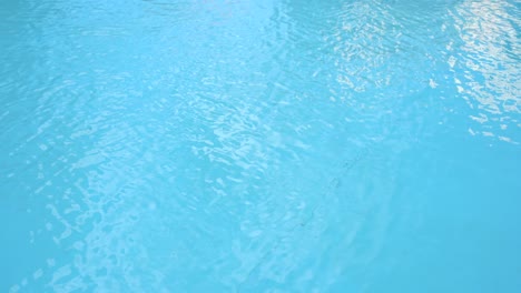 water surface texture, slow motion clean swimming pool ripples and wave, refraction of sunlight top view texture sea side white sand, sun shine water background. water caustic background.