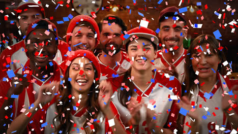 group of fans cheering for their team with confetti