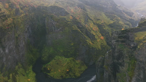 aerial reveal of river cutting through rugged canyon