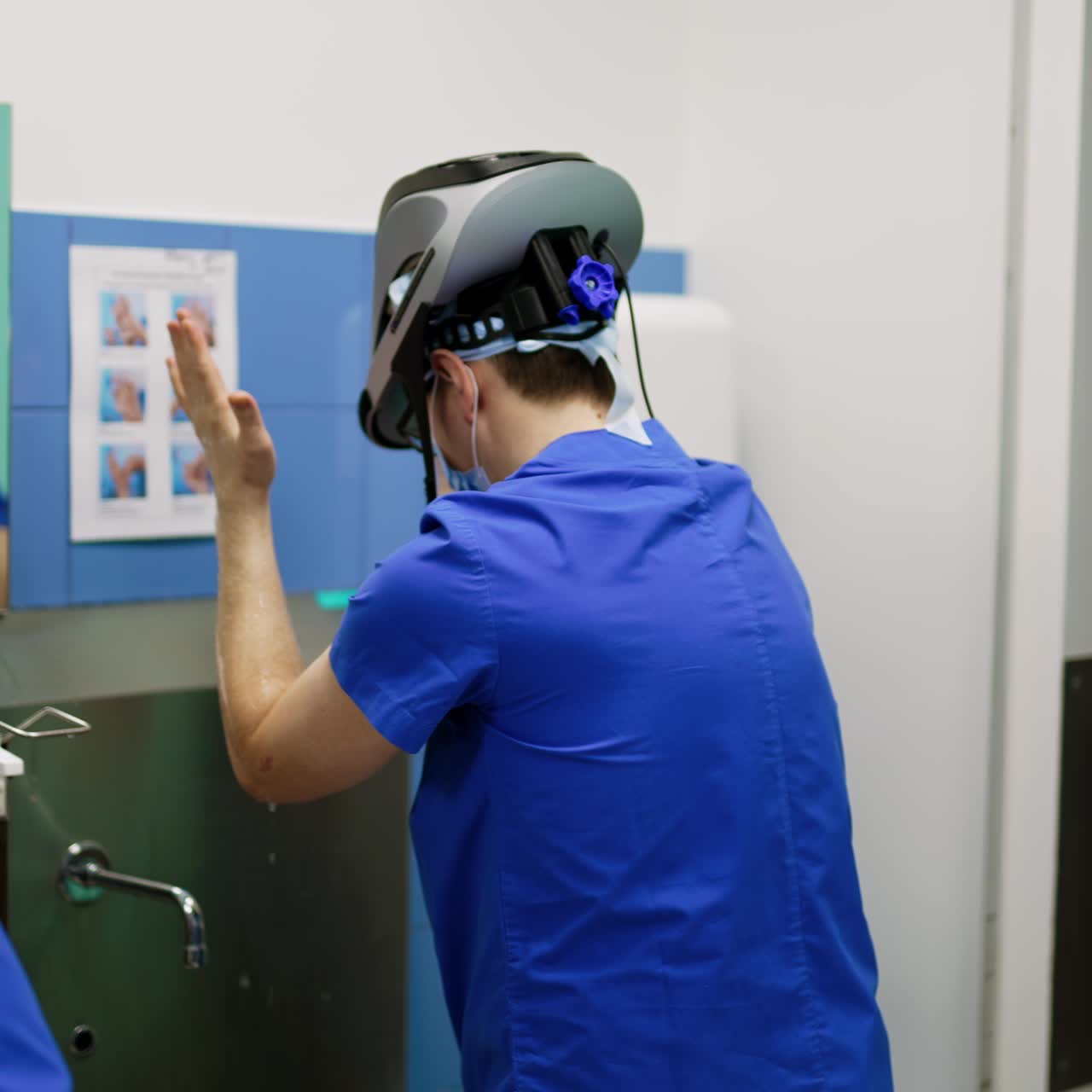 Rare view of two male doctors washing hands in pre-operational room. Medical staff getting ready for surgery