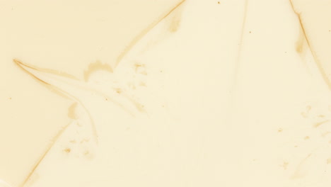 Expansion-of-coffee-brown-liquid-into-white