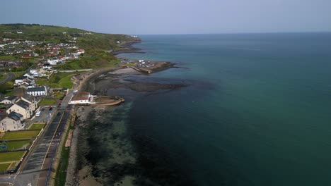 Aerial-shot-of-Whitehead,-a-seaside-village-in-Co