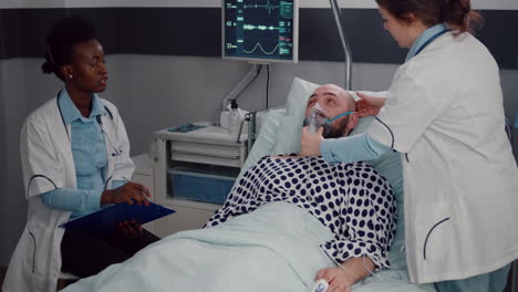 medical team monitoring heartbeat of sick man during respiratory appointment
