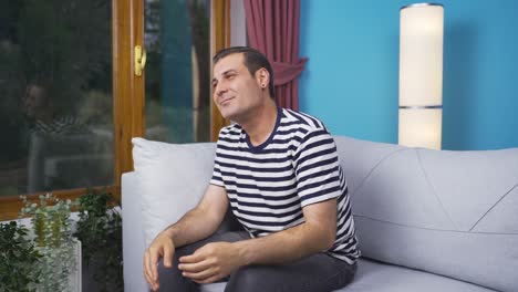 Happy-and-peaceful-man.-He-is-sitting-in-front-of-the-window.