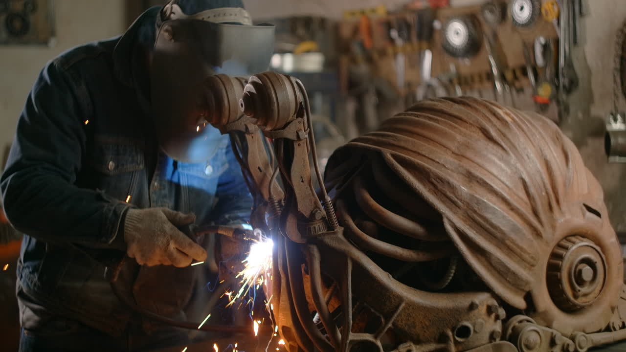 Welding Rusty Metal Sculpture in a Workshop