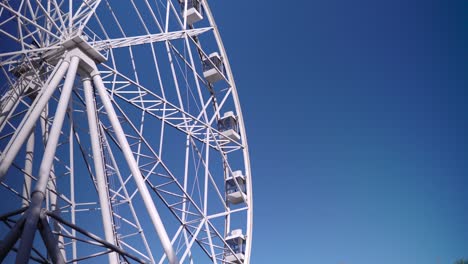 in the park, a large ferris wheel is spinning slowly. high-altitude view wheel