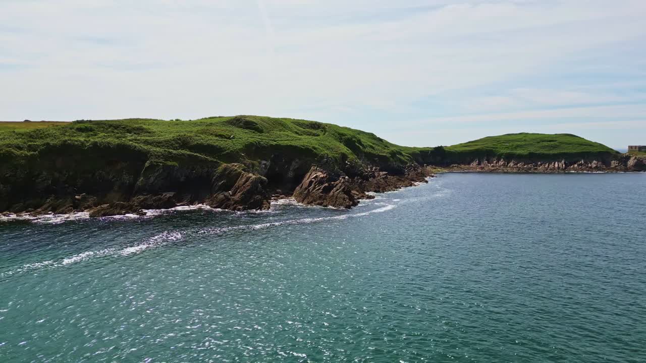Low-altitude panoramic drone movement along the beautiful shoreline of Kermorvan peninsula on a sunny daytime, Le Conquet, Brittany, France.