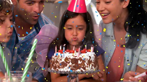 Animation-of-confetti-falling-over-girl-and-family-blowing-out-candles-on-birthday-cake