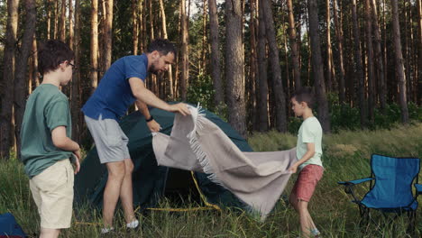 man and kid camping in the nature