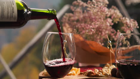 pouring red wine into a glass