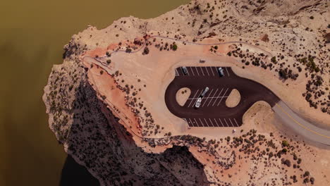 aerial view of scenic cliffside parking area by a lake