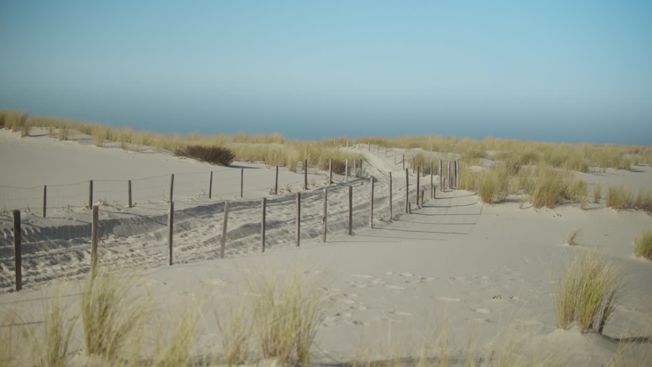 Beautiful scene of salt meadow and sand road in sunny day. Gimbal tilt up