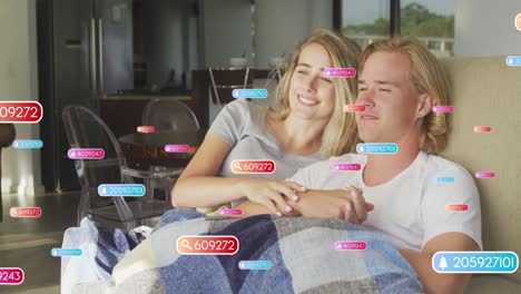 animation of network of connections with icons over man and woman using laptop