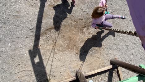 Overhead-shot-of-a-girl-spinning-on-a-swing-in-the-park