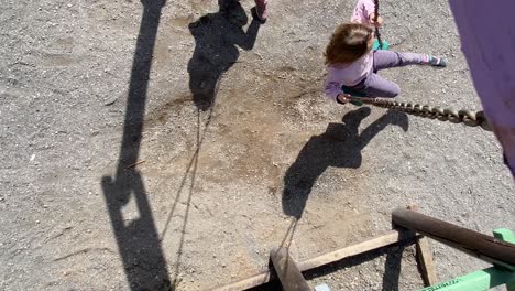 overhead shot of a girl spinning on a swing in the park