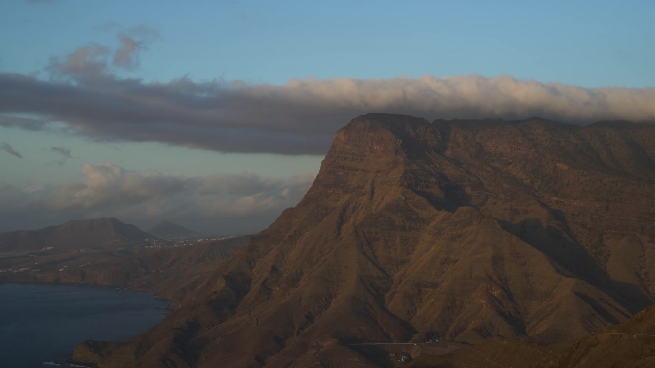 Fantastic shot of Faneque Cliff with clouds brushing over it. On the island of Gran Canaria, Canary Islands, Spain