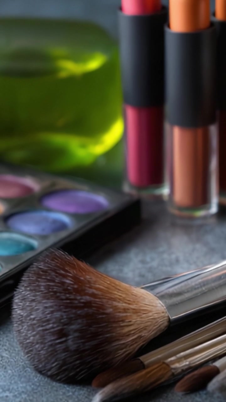A Vibrant Display of Makeup Tools and Products Featuring Brushes, Lipsticks, and Eyeshadow Palettes on a Stylish Surface for Beauty Enthusiasts