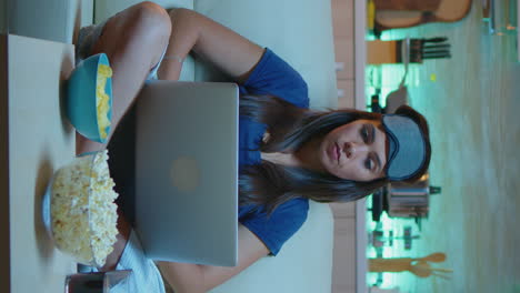 vertical video: typing on laptop and watching tv