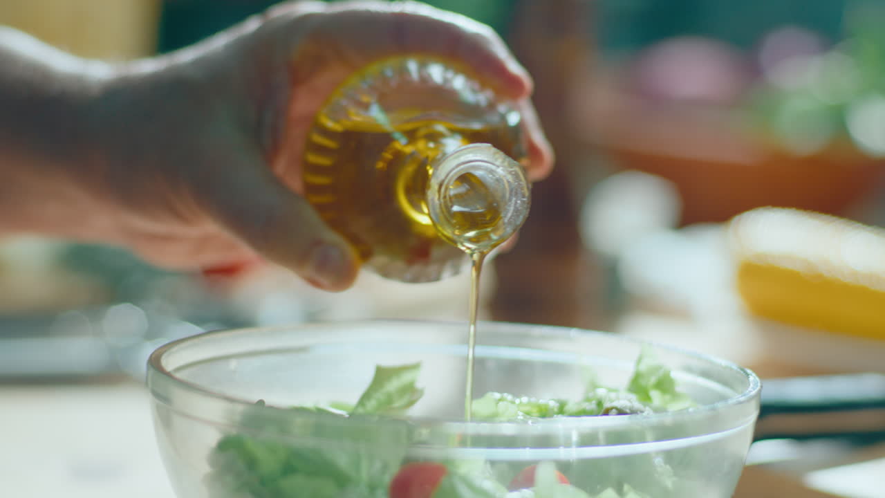 Making a fresh salad with olive oil