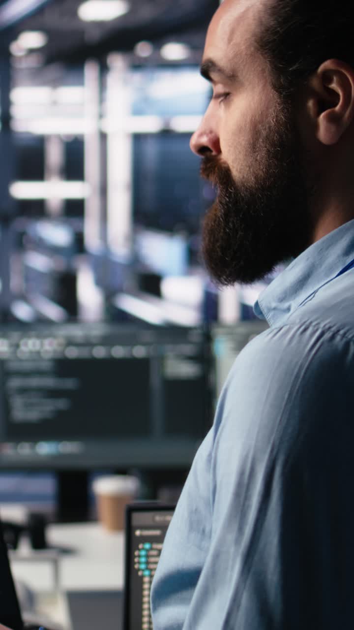 Vertical video Close up of developer in data center coding with generative AI on laptop