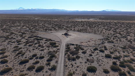 A drone flies to a lone pumpjack operating in remote Mendoza, Argentina’s dry landscape