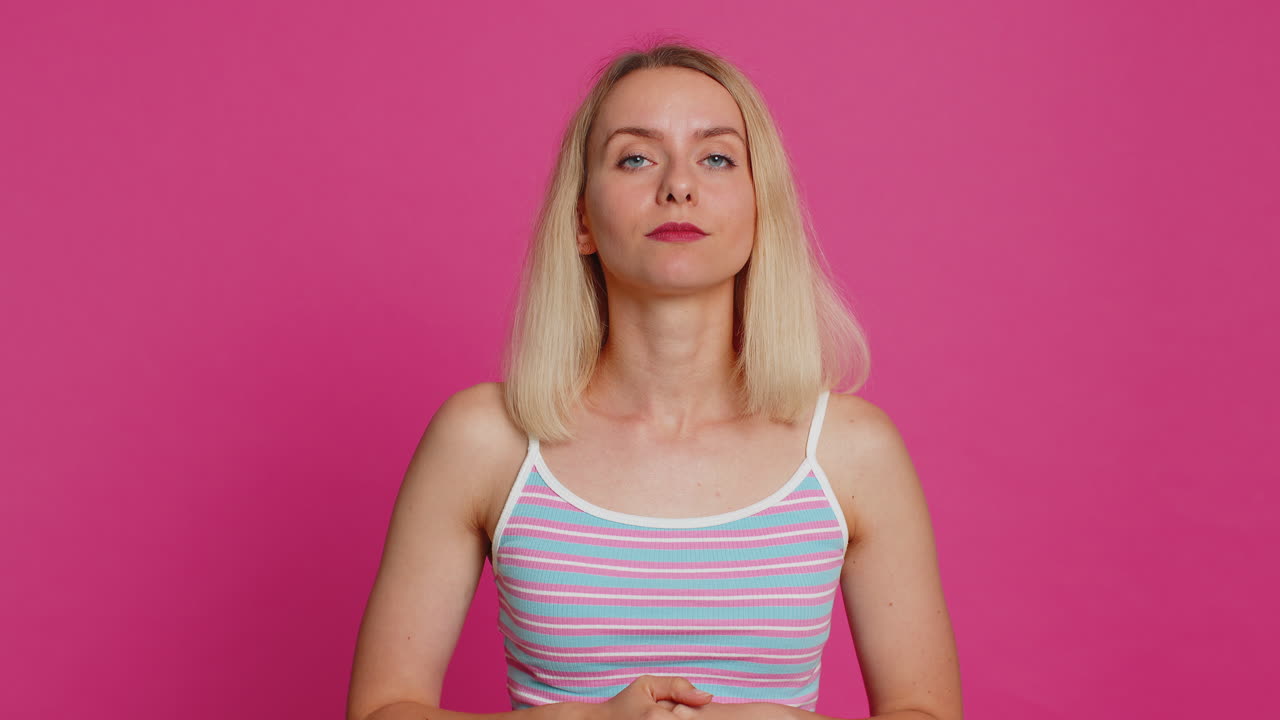 Caucasian young woman praying making wish asking hopeful help begging apology meditation imploring