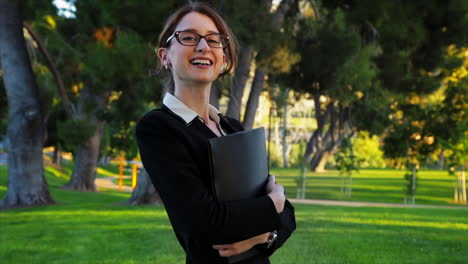 Attractive-caucasian-business-woman-looks-at-the-camera-with-a-huge-smile-and-laugh