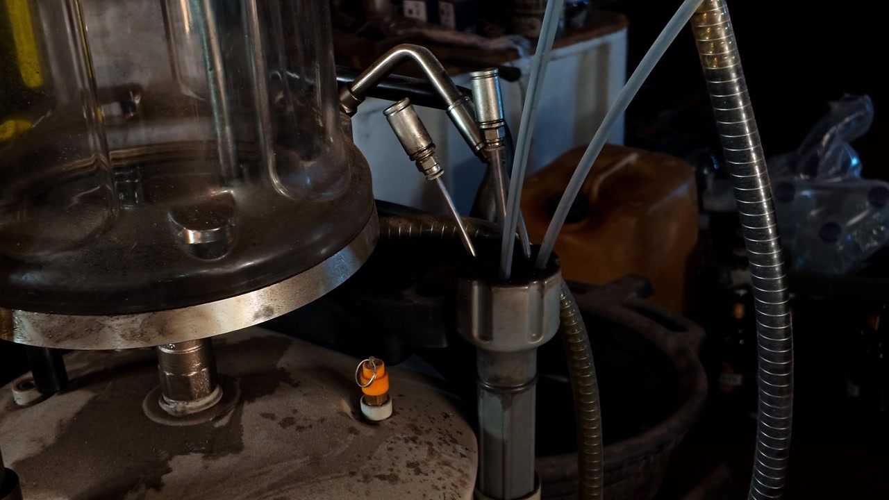 Professional mechanic equipment changing automotive oil fluids during vehicle maintenance service