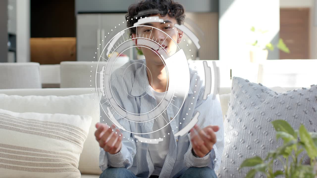 Man on sofa reacting to circular HUD appearing, interacting with wireframe and data bars for design