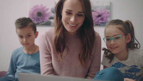 mother with kids skype calling to father. video conversation at home