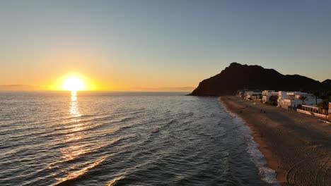 Drone-runs-along-the-shoreline-of-the-beach-in-a-backwards-shot