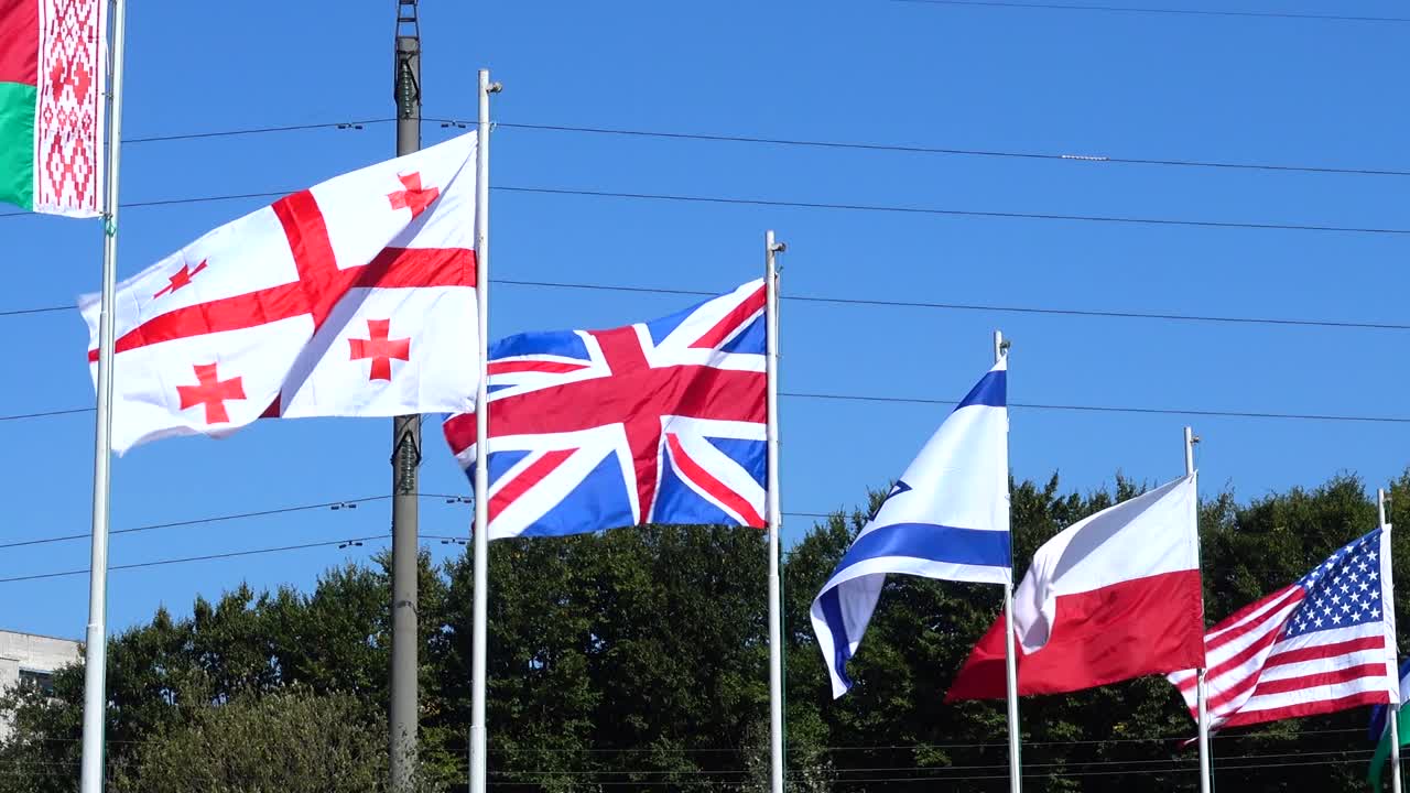 Flags of Belarus, Georgia, Great Britain, Israel, Poland, USA, Uzbekistan and Ukraine on flagpoles