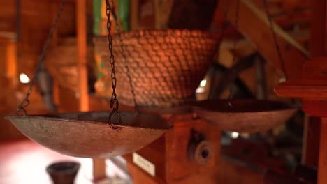 Vintage-metallic-balance-scales-inside-of-an-old-watermill