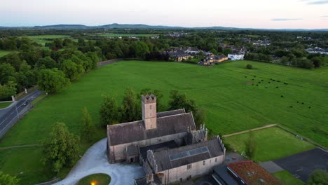 drone flying over st nicholas church and augustinian friary, animals grazing