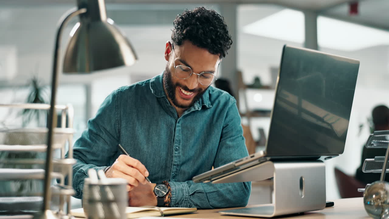 Man working on laptop at desk in office