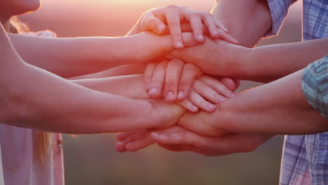 A Group Of People Of Different Ages Puts Their Hands On One Another Teamwork Concept