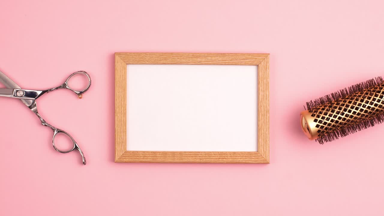Stop motion animation of wooden picture frame mockup flat lay of professional hair cutting shears, gold round hair brush for styling template on pink background. Hairdresser salon equipment set