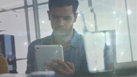 animation of network of connections over biracial businessman using tablet in office