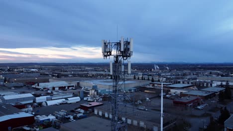 drone shot of a radio cell tower in an industrial area