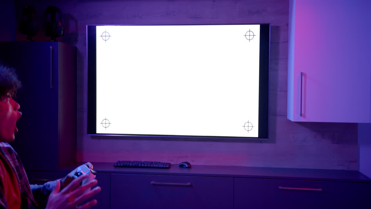 Playing video game, man holding controller and looking at blank TV screen, copy space