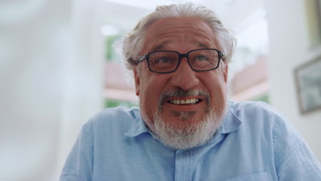 Portrait-of-emotional-senior-man-smiling-at-home