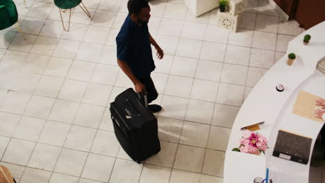 male tourist arriving at hotel reception