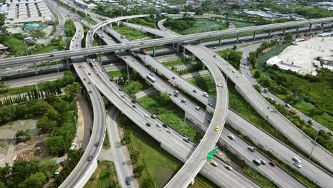 aerial view of road interchange of highway intersection with busy urban traffic speeding on the road. junction network of transportation taken by drone.