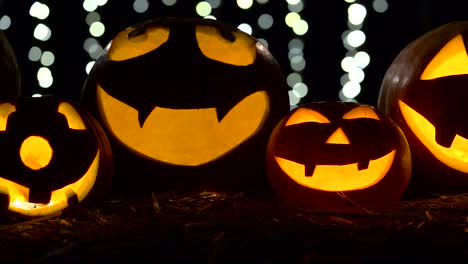 halloween and holidays concept - spooky jack-o-lantern or carved pumpkin lantern burning in darkness