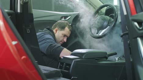 professional car cleaning. сar wash. interior detailing. dry clean and detail a car interior. deep seats cleaning. wiping foam in car wash. cleaning the car panel from dust. a vacuum cleaner