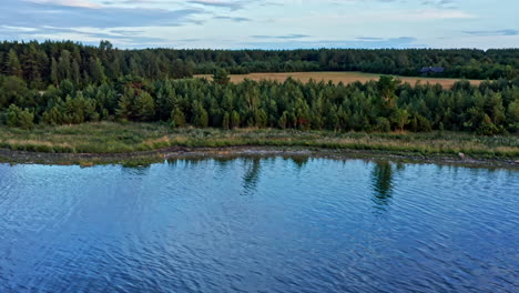 Beautiful-scene-of-reflective-sea-by-the-coastline-during-evening-hours