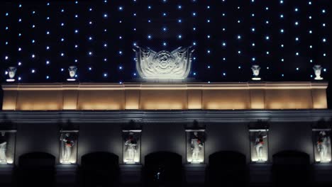 historical building at night with decorative lights and statues