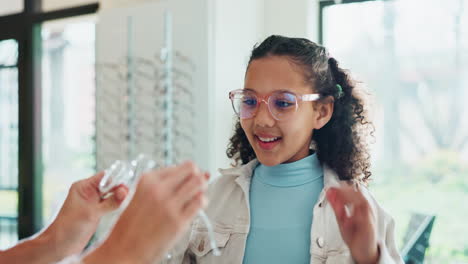 child trying on glasses at the optician