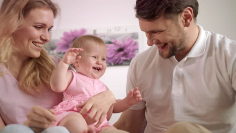 happy parents playing with baby. portrait of sweet family together