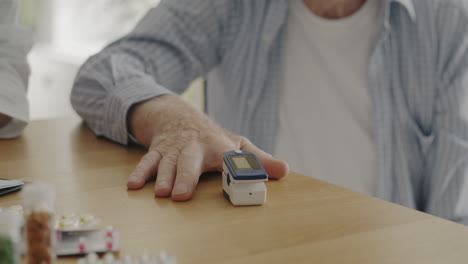 doctor checking pulse oximeter on elderly patient